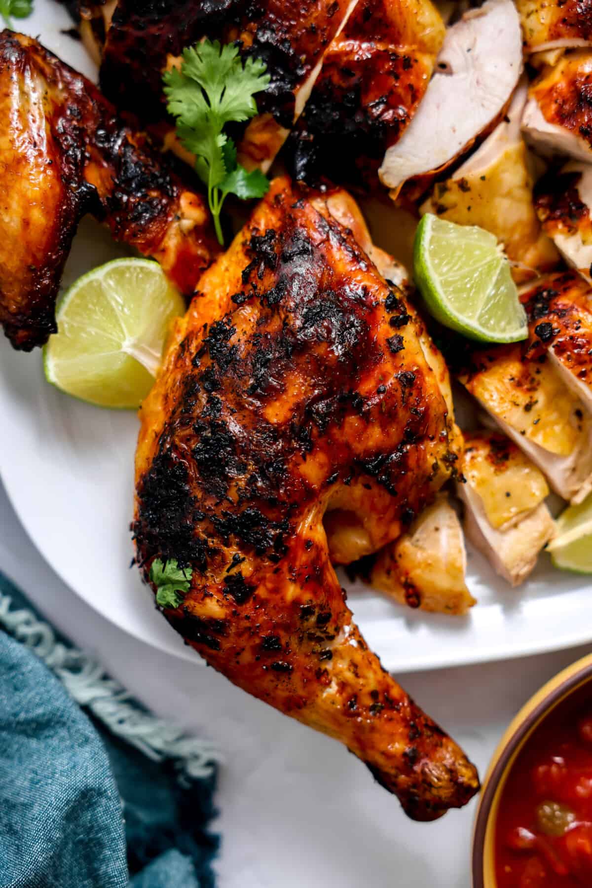 Grilled pollo asado chicken leg on a plate. 
