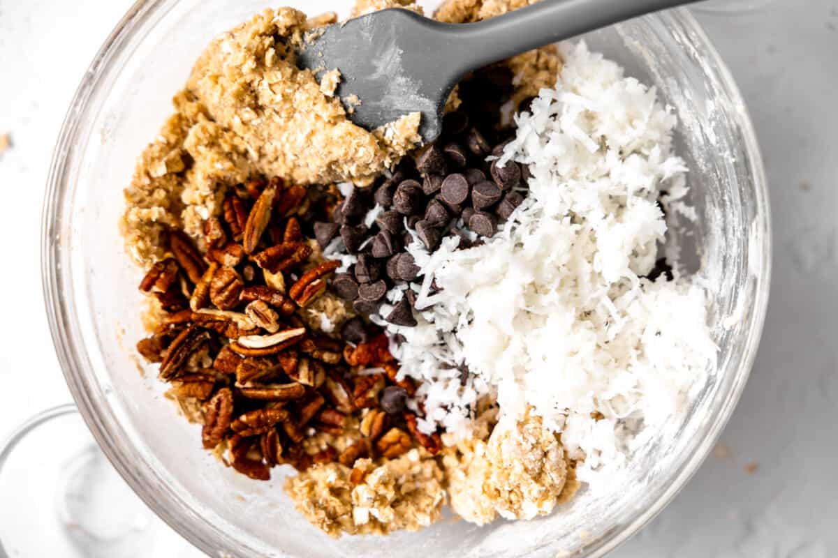 Shredded coconut, chocolate chips, and pecans added to cookie dough. 