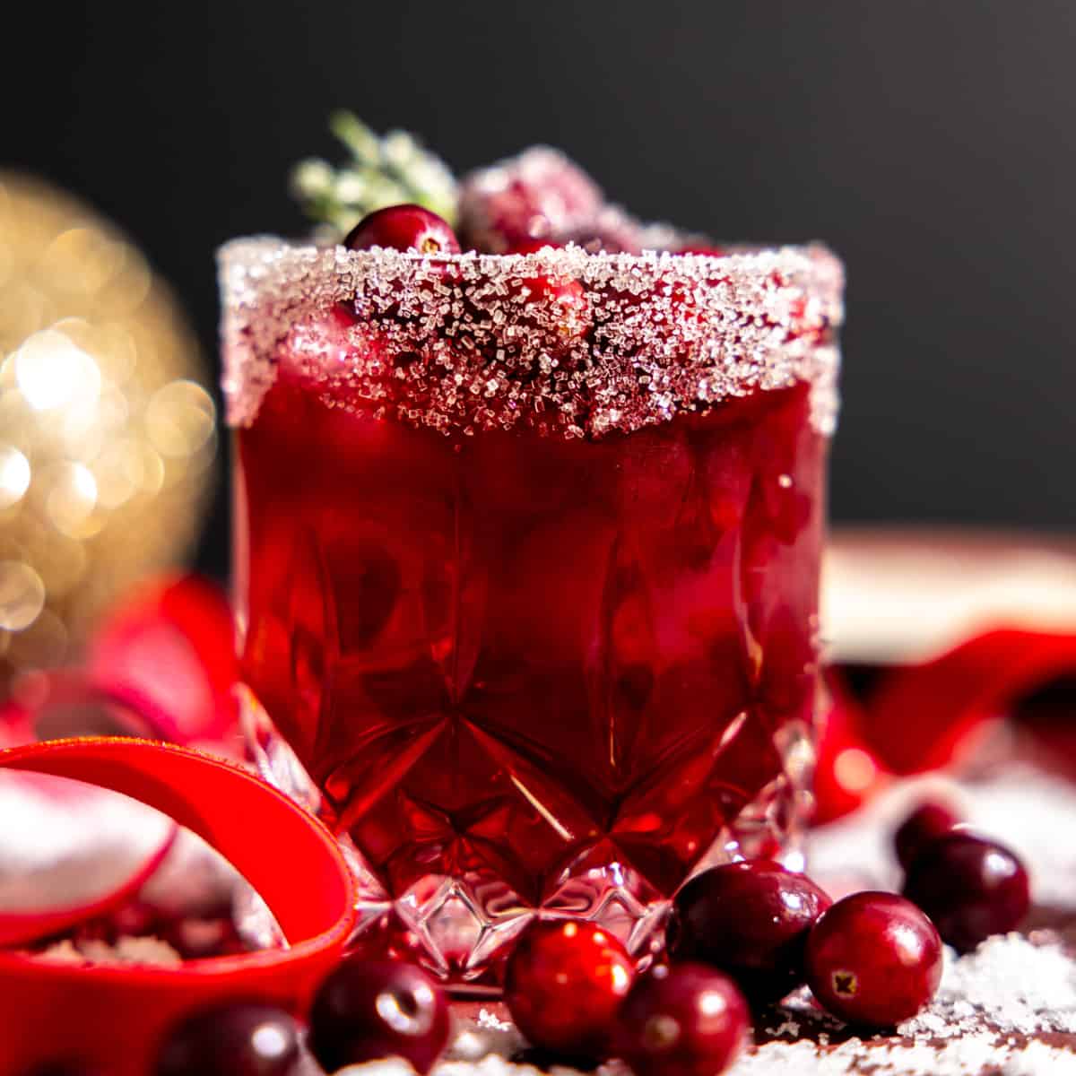 Glass filled with cranberry margarita and a sugar rim.