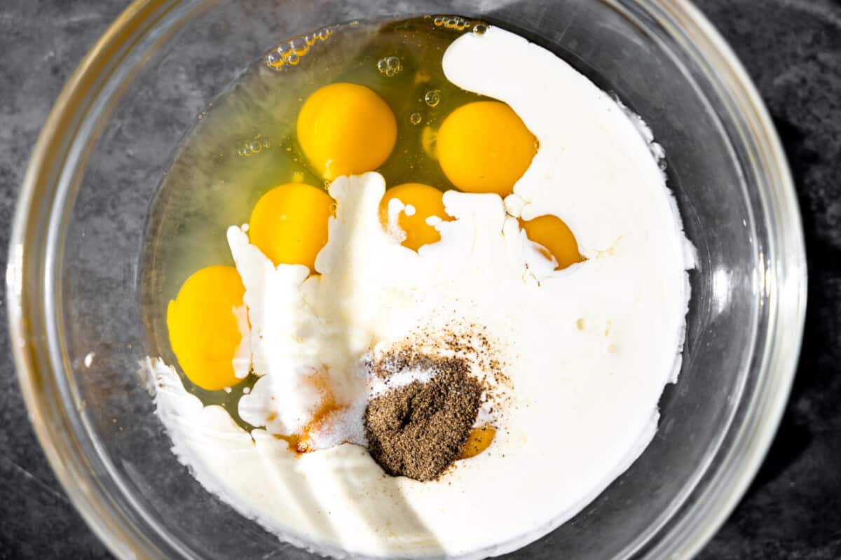 Glass bowl with eggs and milk. 