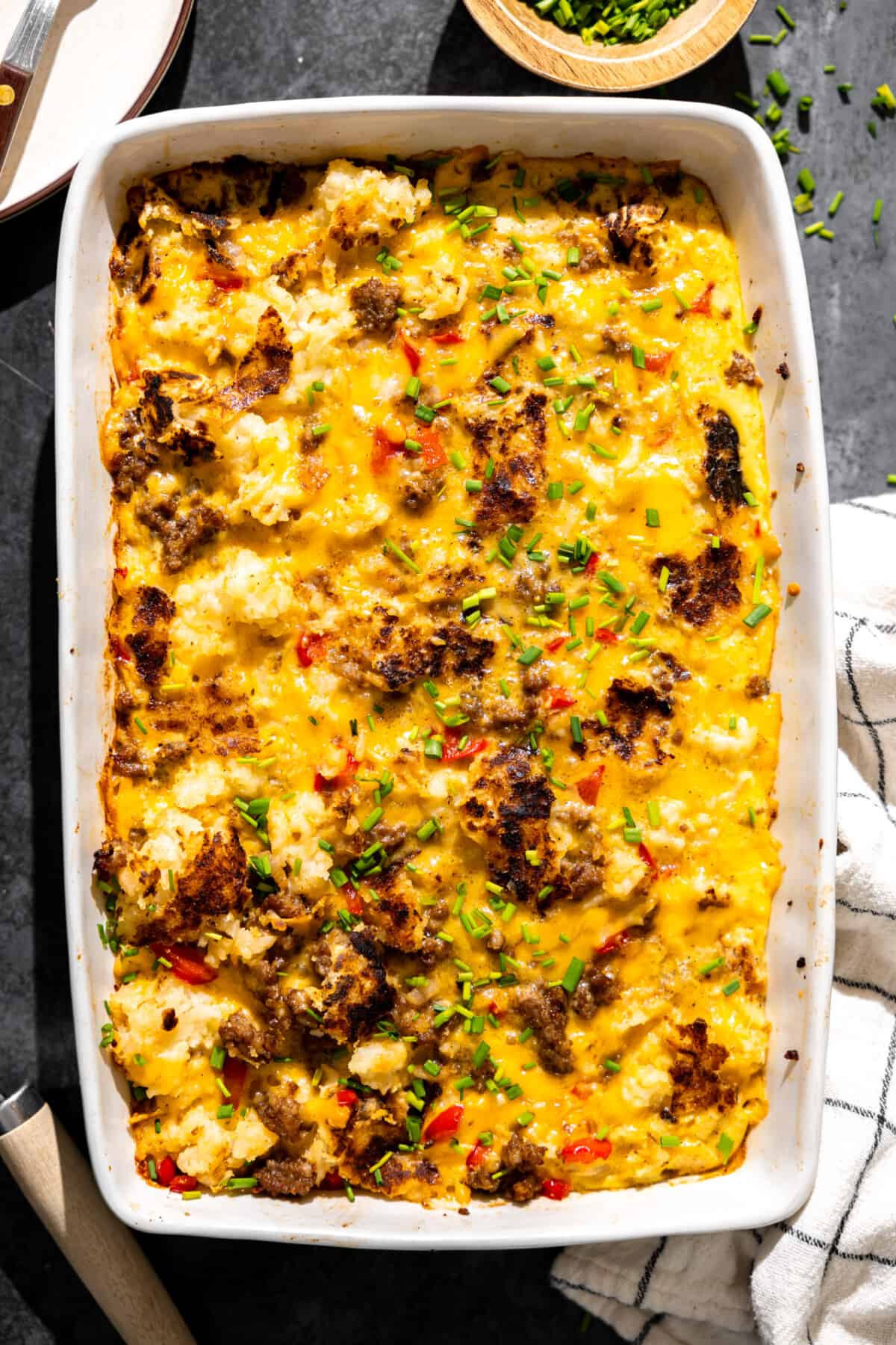 Hashbrown breakfast casserole in a white baking dish. 