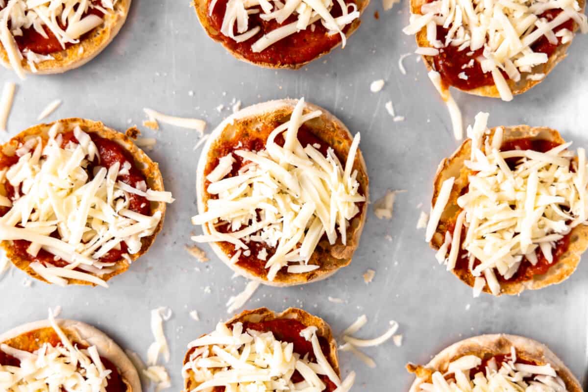 Cheese sprinkled on English muffins. 