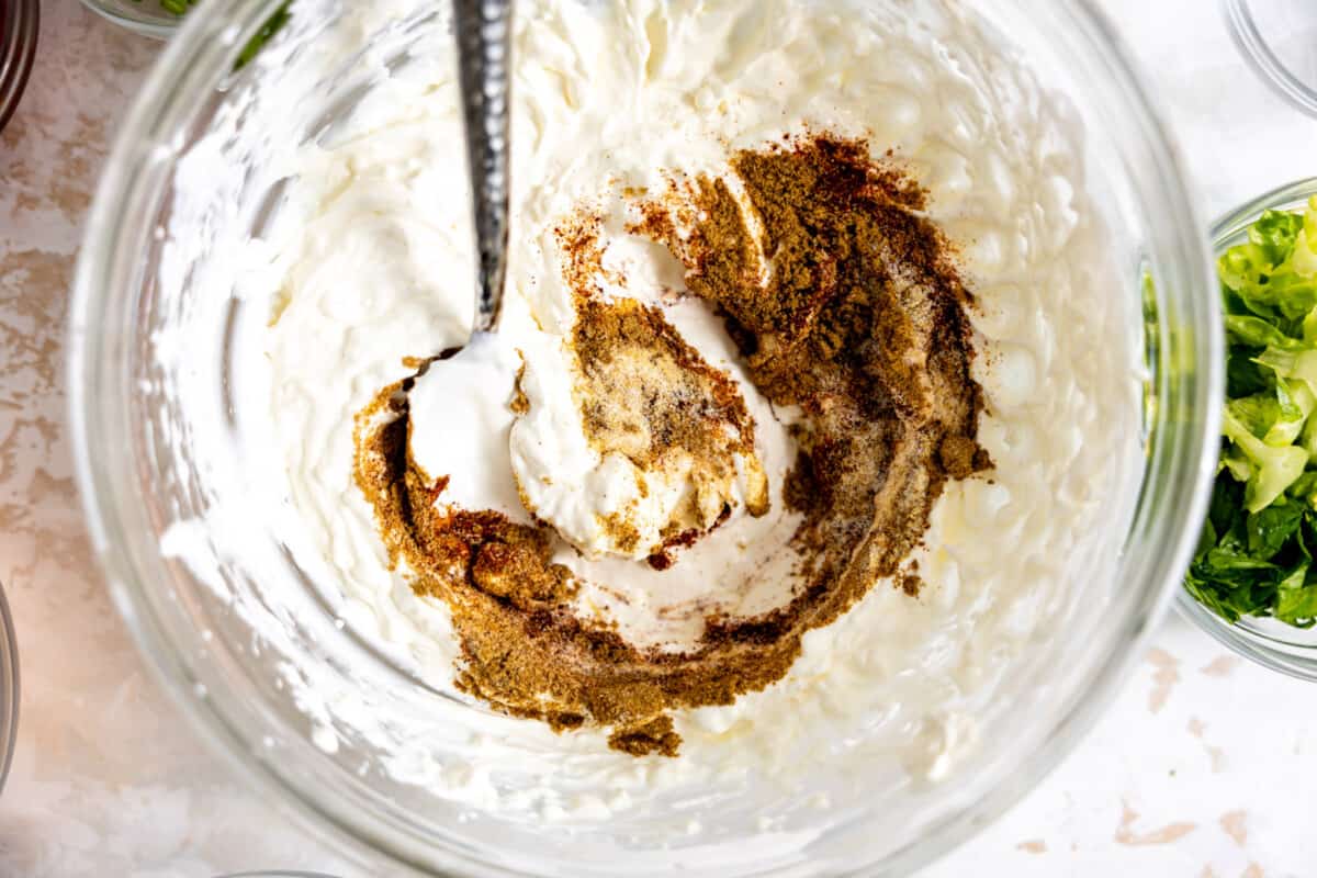 Homemade taco seasoning blend in cream cheese and sour cream for taco dip.