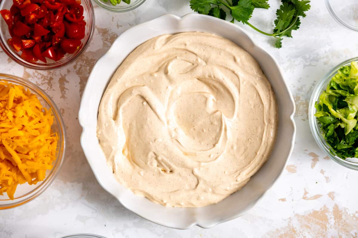 Taco dip spread in white serving bowl.