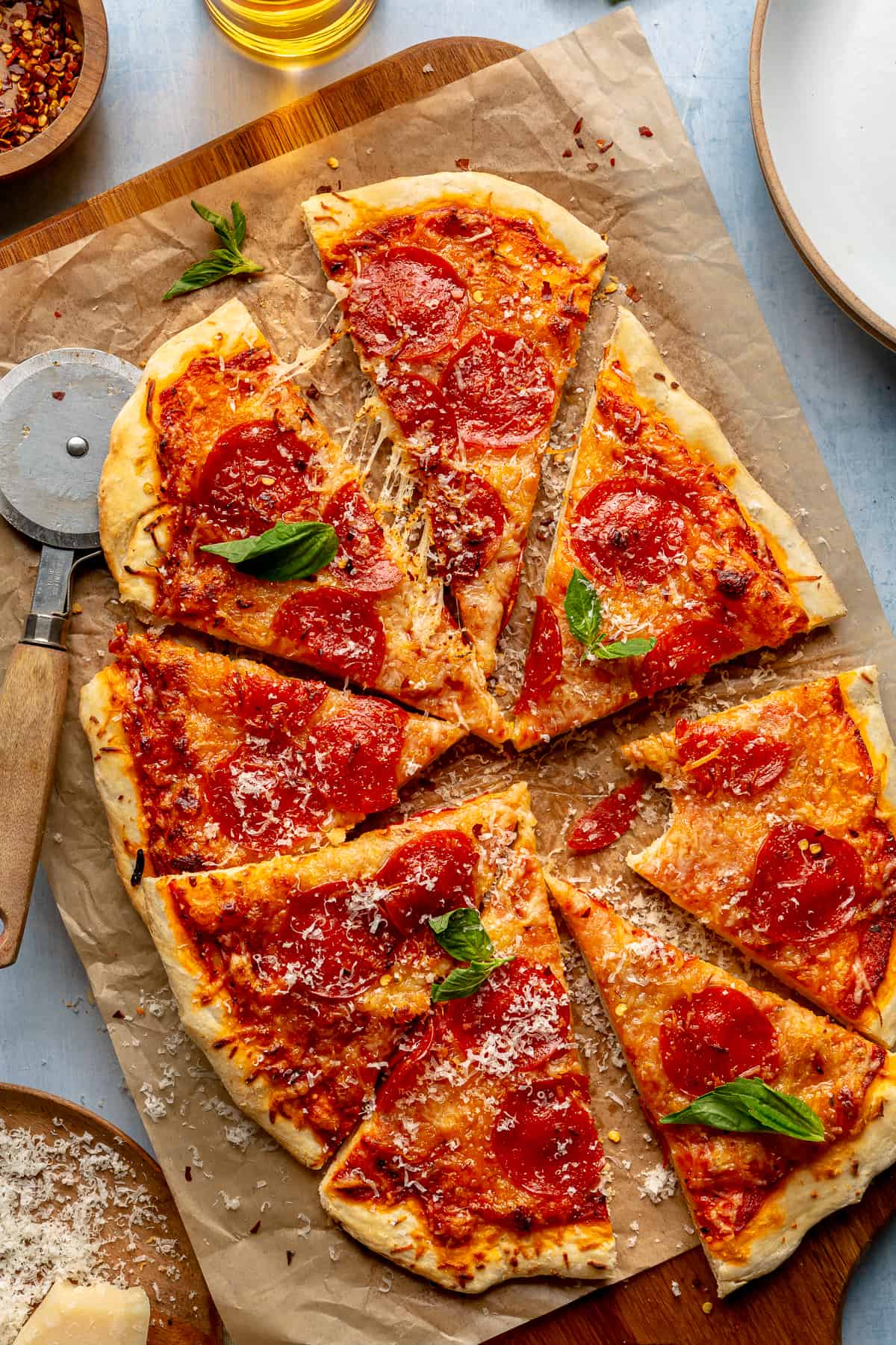 Sliced pepperoni pizza with fresh basil on top. 
