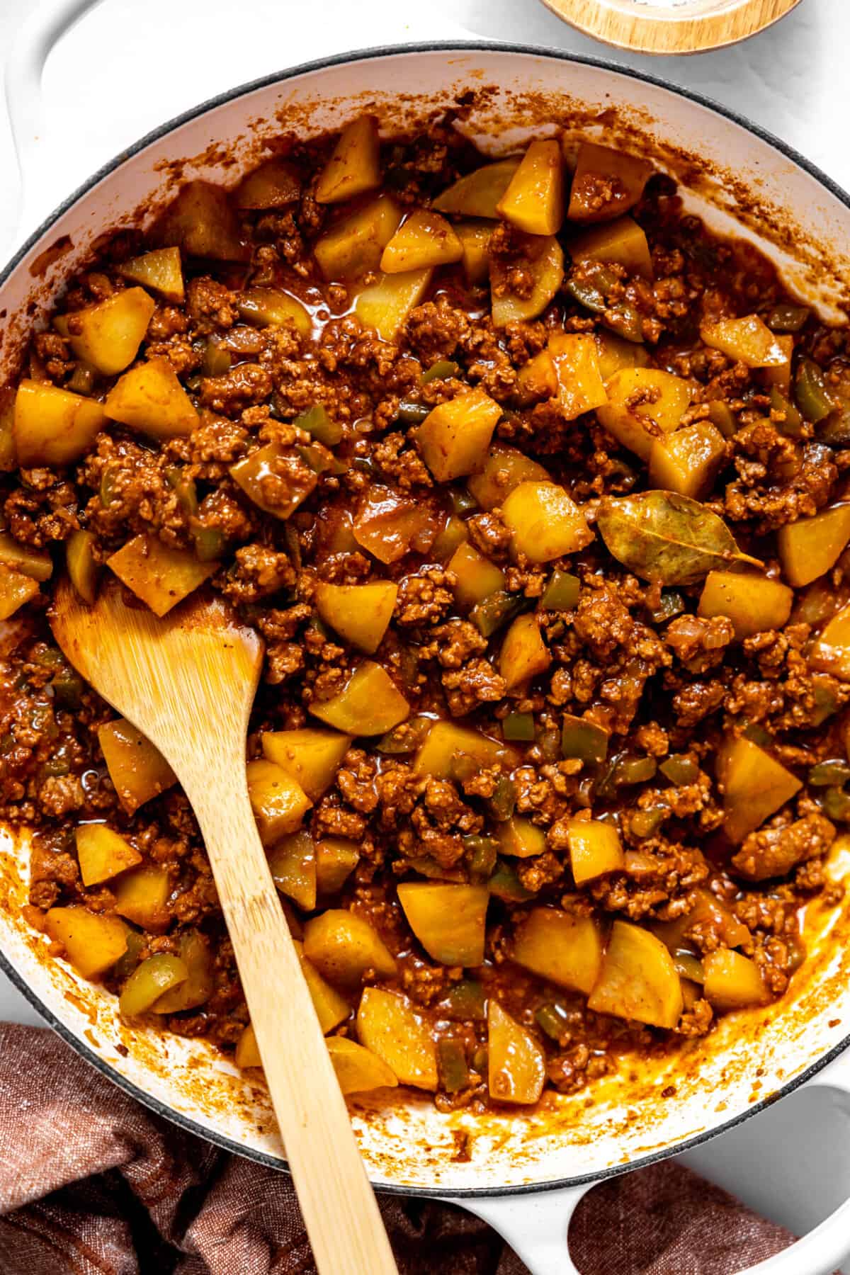 Skillet filled with Mexican picadillo.