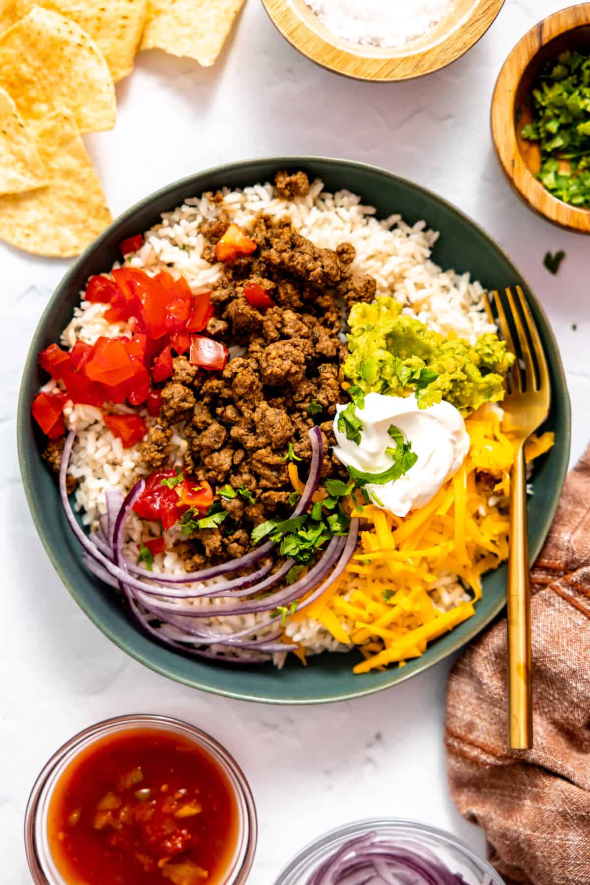 Taco bowl served over rice topped with sour cream. 