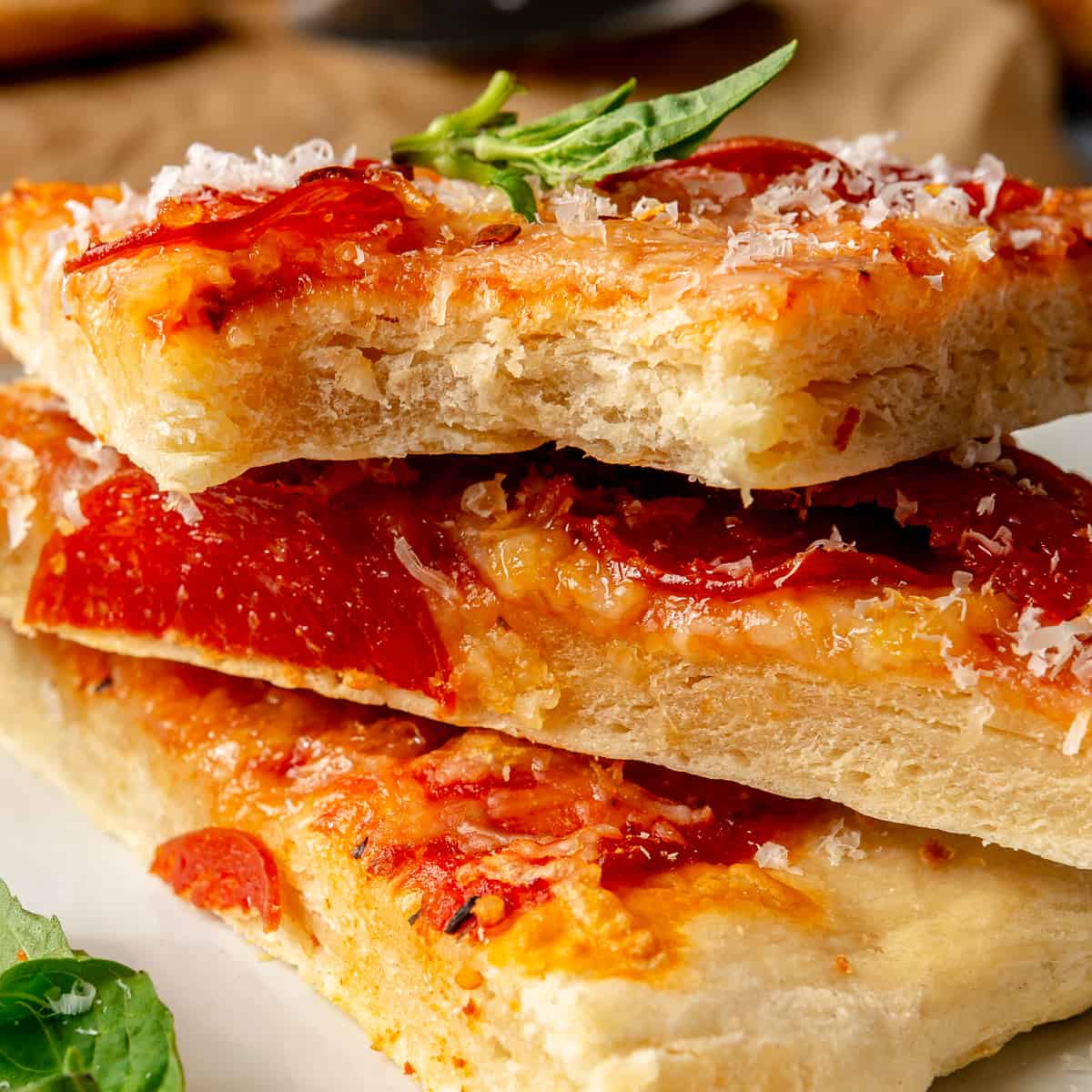 Stacked pepperoni pizza slices.