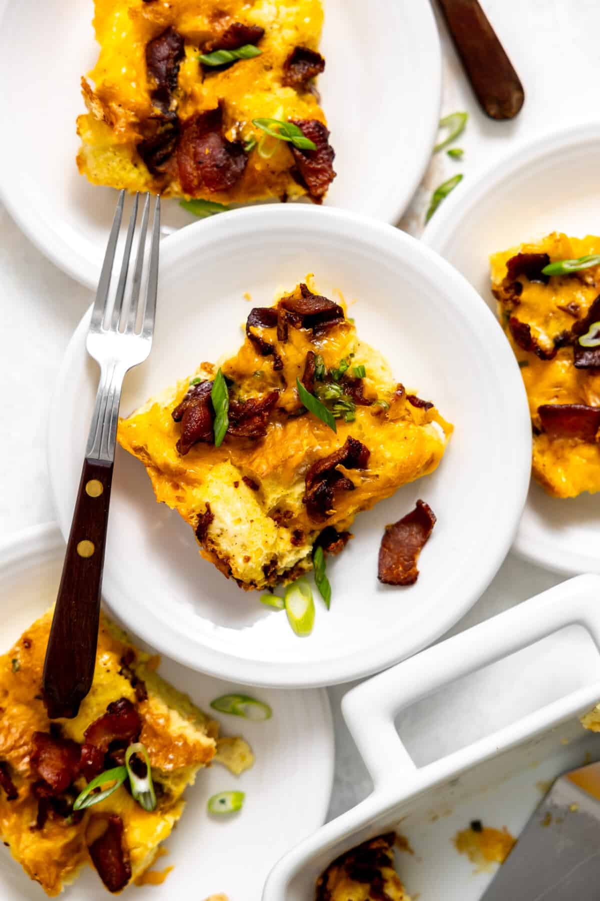 Plates with bacon and cheese strata being served.