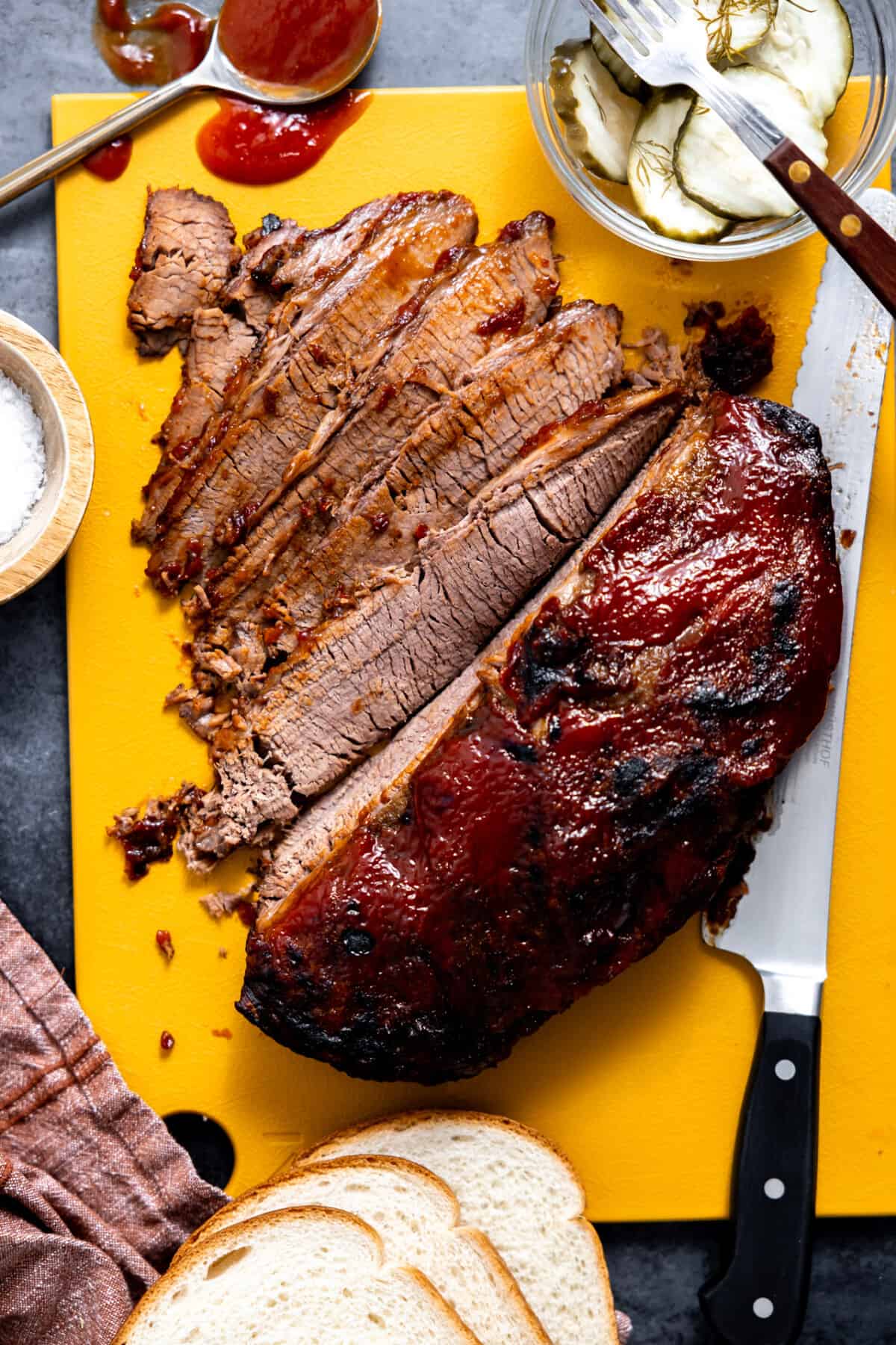 Sliced beef brisket on a cutting board.
