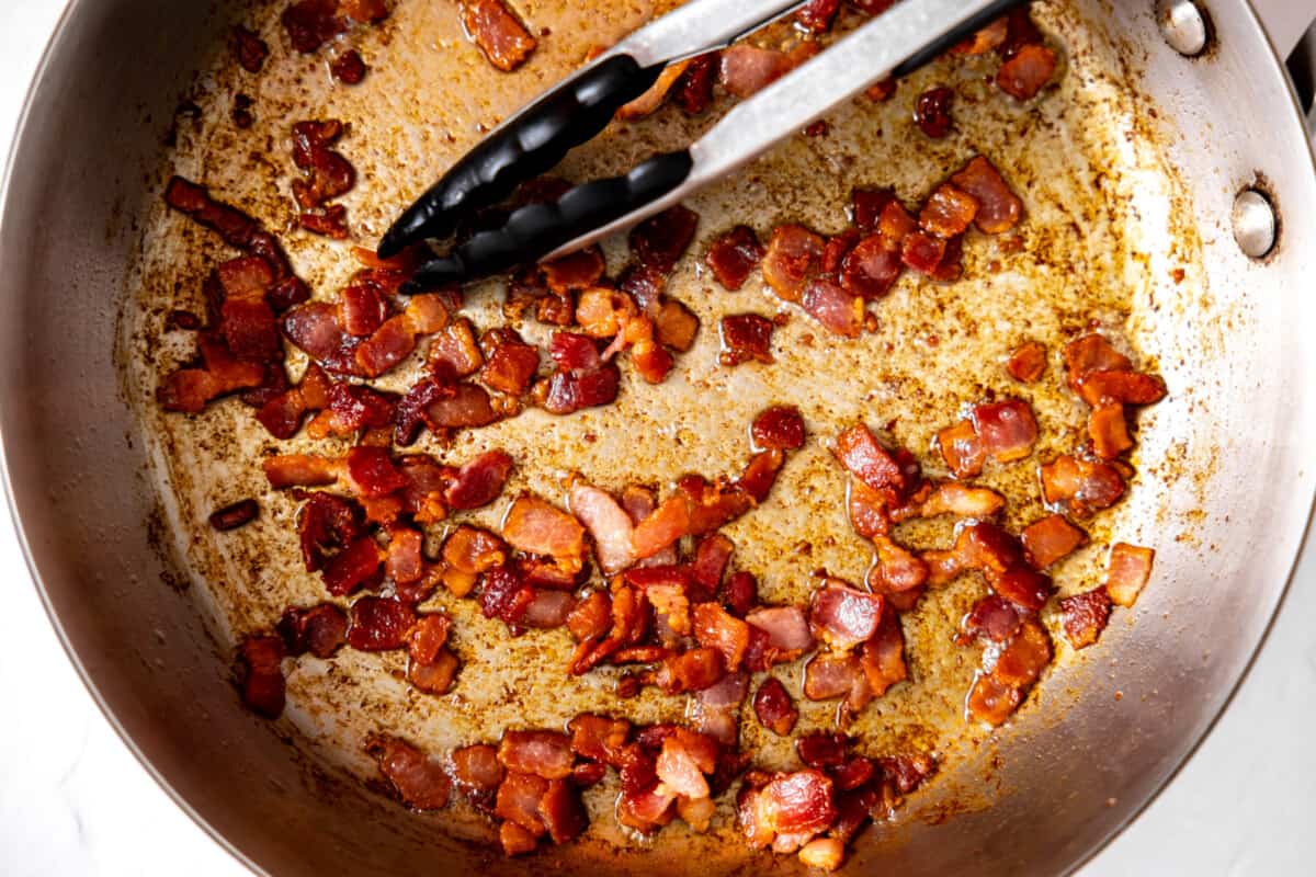 Bacon cooking in a skillet. 