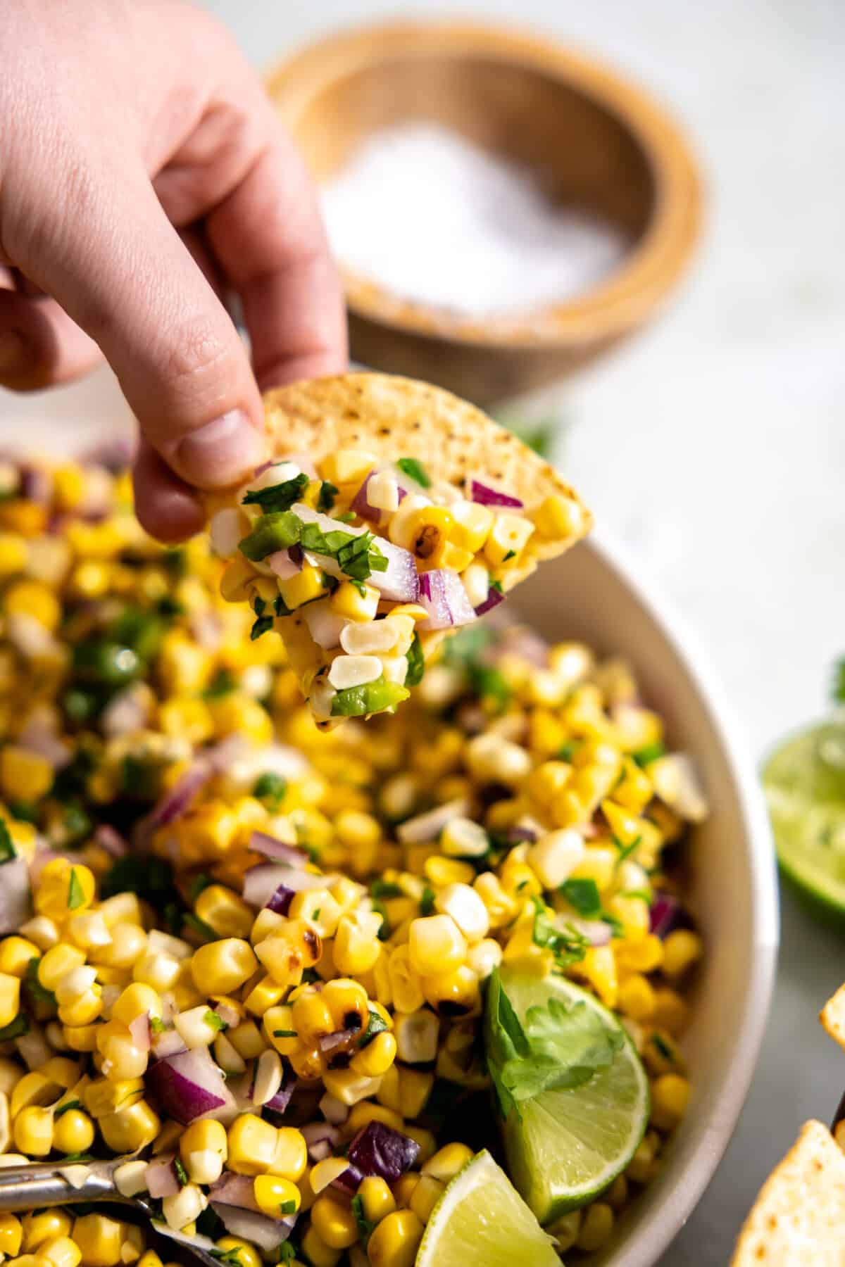 Roasted corn salsa served on a tortilla chip.