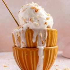 Stacked bowls with coconut sorbet topped with toasted flakes of coconut.