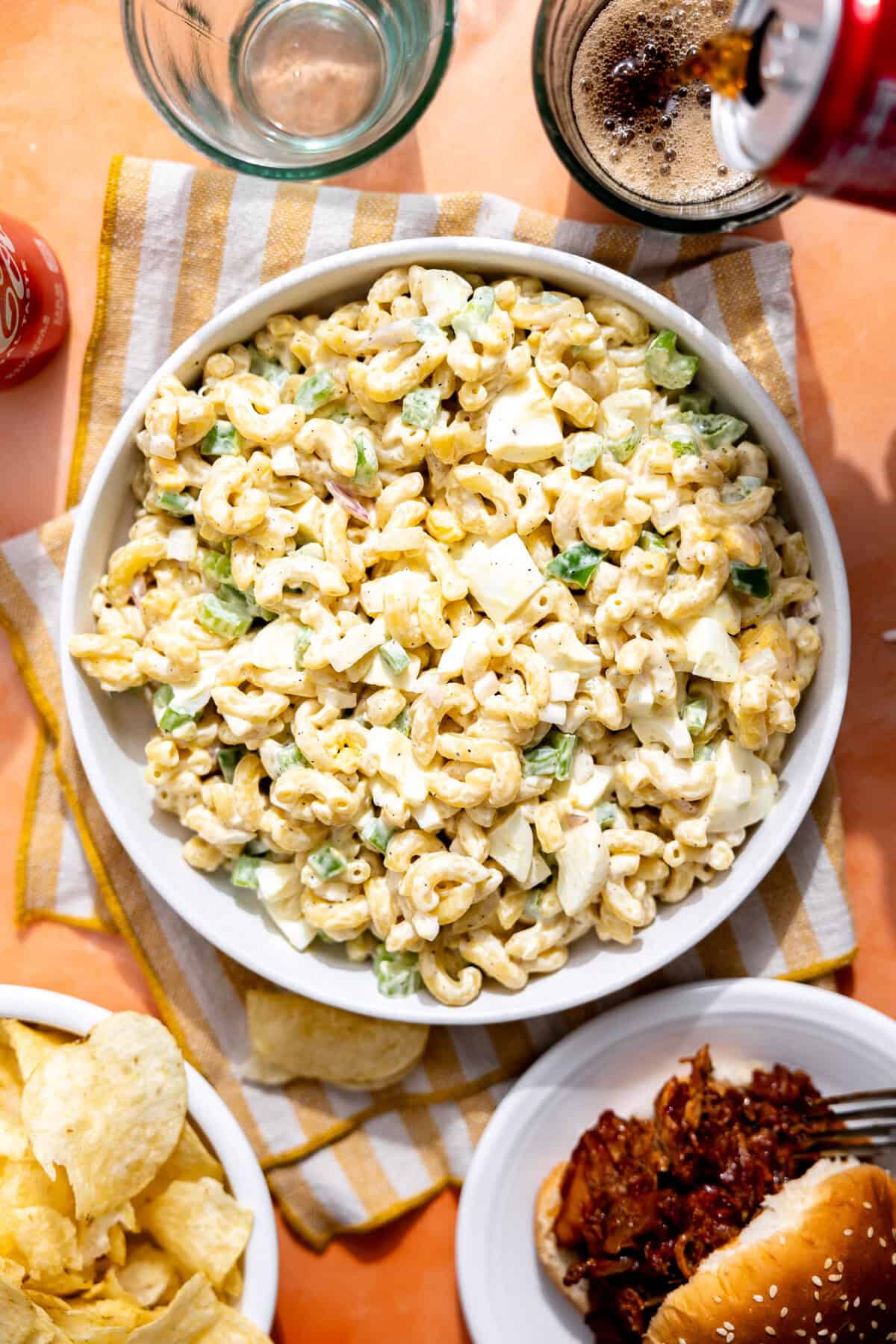 Bowl of macaroni salad on a picnic table.