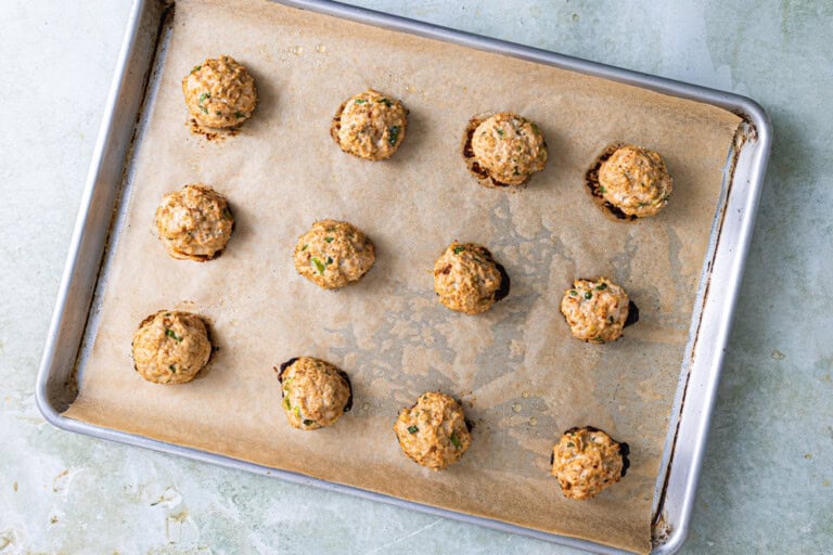 Baked chicken meatballs on a sheet pan.