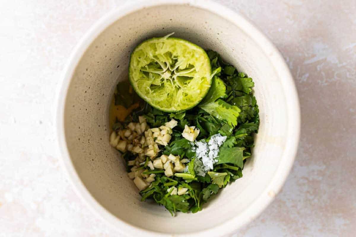 Small bowl with ingredients for cilantro lime vinaigrette.