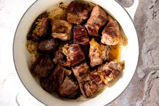 Seared chuck roast in a skillet.